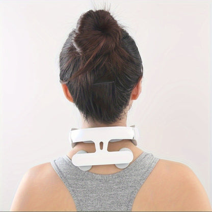 Person wearing a white neck massager against a plain background
