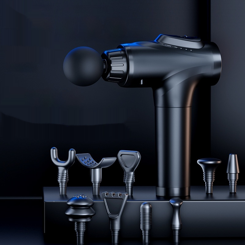 Black massage gun with various attachments on a dark background