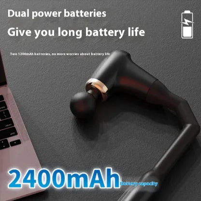 Black wireless earbuds with 2400mAh capacity text on a dark surface with laptop.